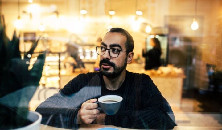 Man drinking coffee thinking