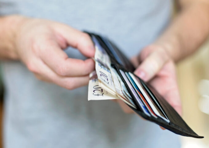 Man with bipolar opens his wallet full of cash