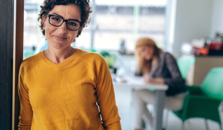 Woman leaning against door