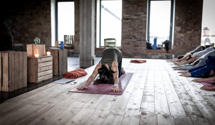 Woman practices yoga on a mat