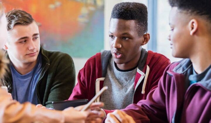 Three young men talking about exam stress