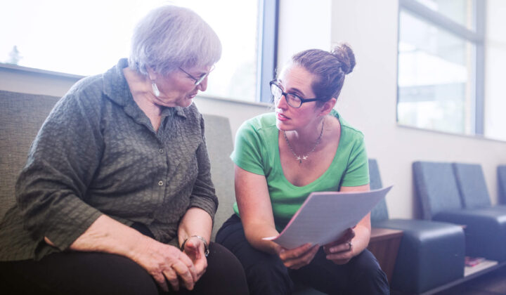 Senior Adult Woman Filling Out Paperwork