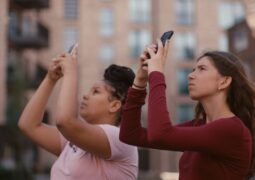 Two young girls taking photos