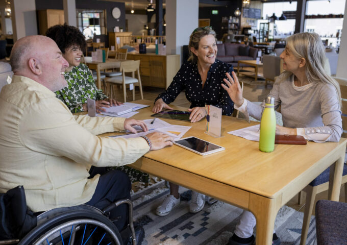 Team members with client discussing new work