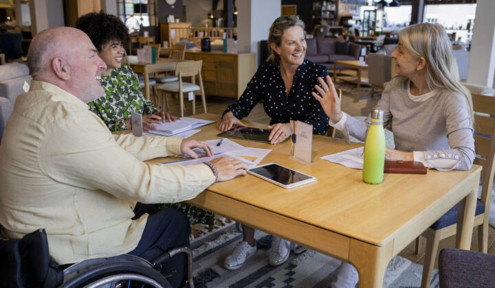 Team members with client discussing new work