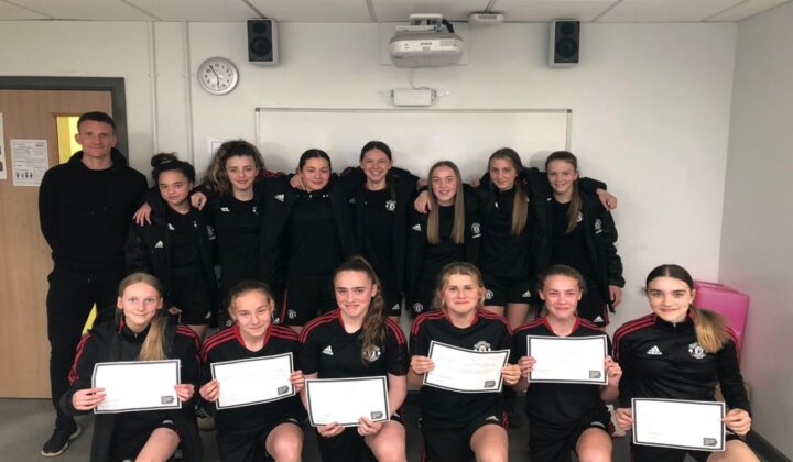 Manchester United young people showing Your Resilience certificates