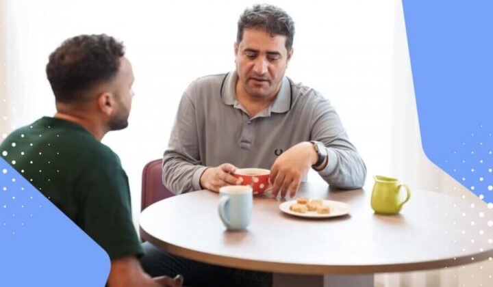 Two men talking and drinking tea