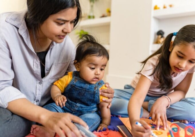 Mother and two children playing