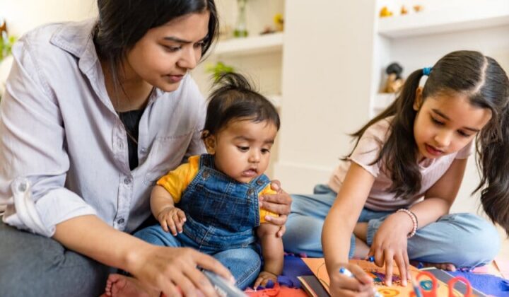 Mother and two children playing