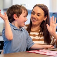 Parent counting money with child