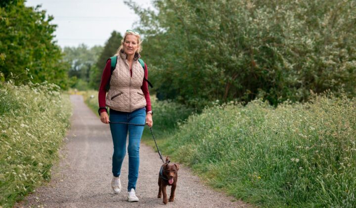Lady walking her dog in the countryside