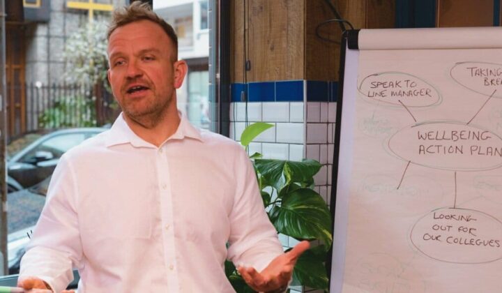 Man in front of flipchart providing training
