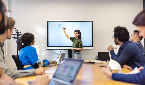 Group of people staring at a presentations being trained