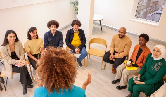 Group of people in a circle being trained