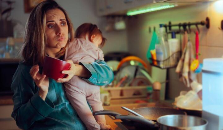 Mother juggling cooking and parenting