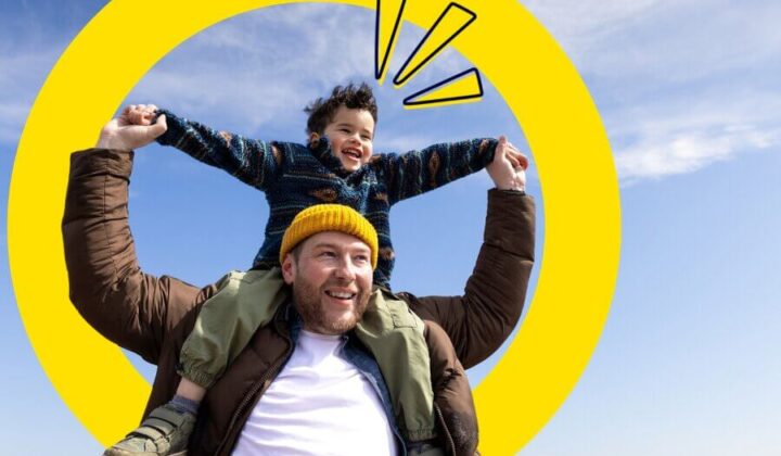 Dad with his son on his shoulders outside