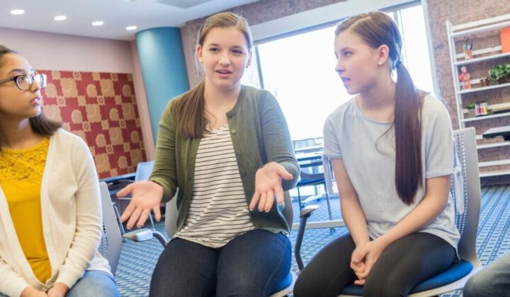 Group of young people talking in community space