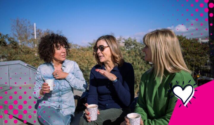 Three ladies chatting and sipping coffee outdoors
