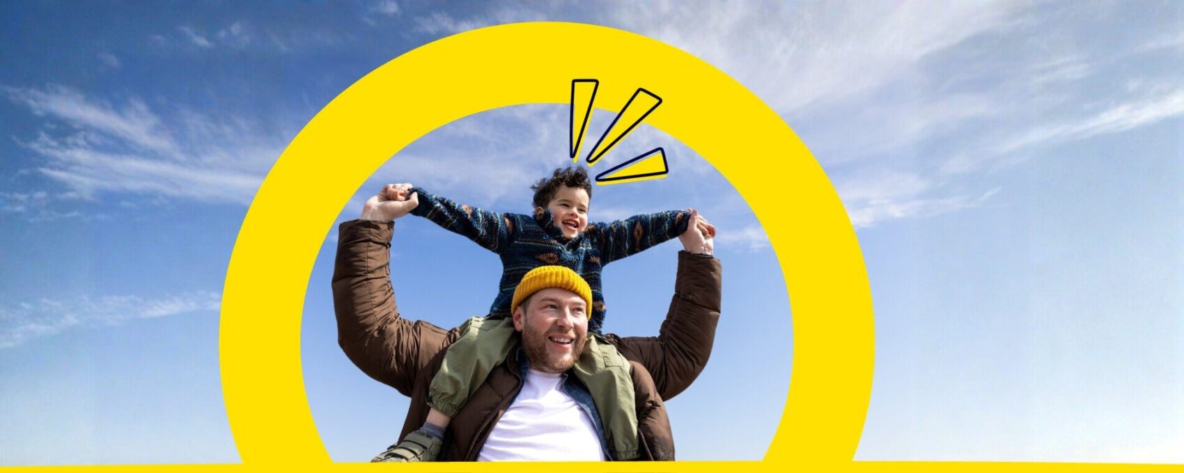 Dad with his son on his shoulders outside