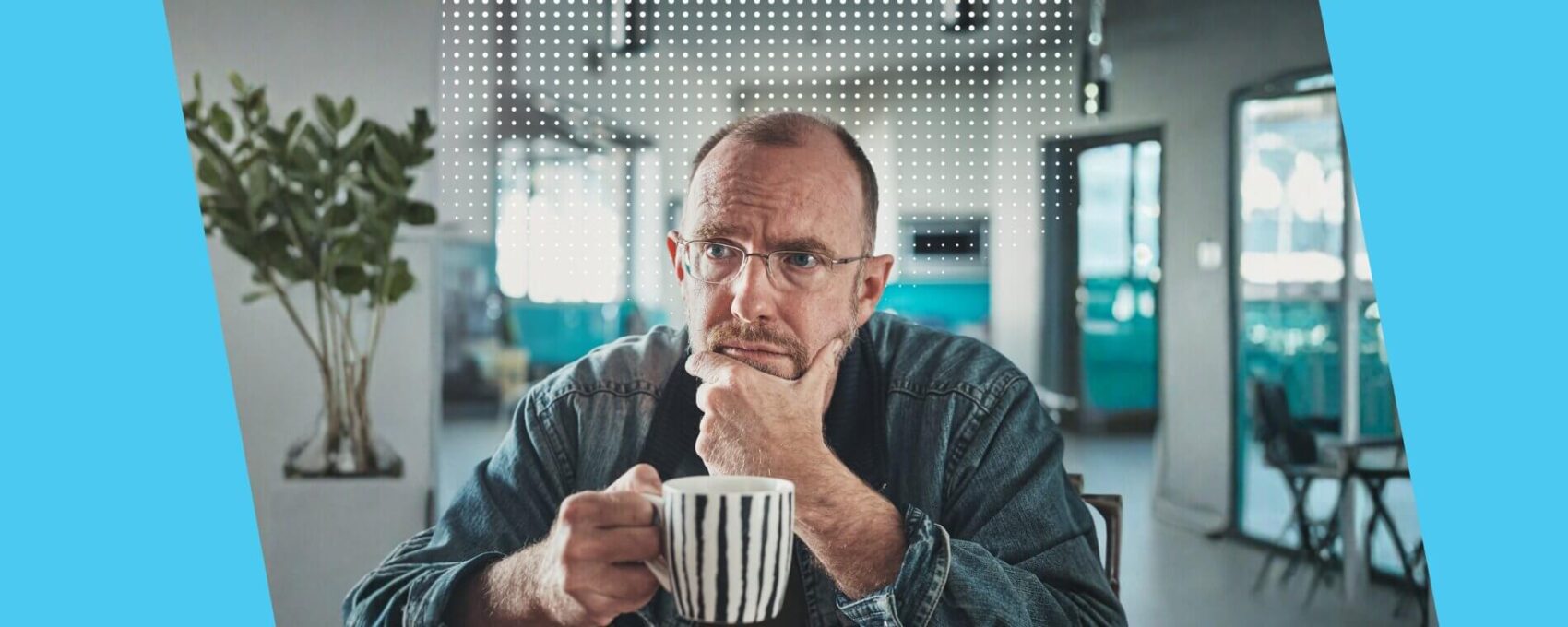 Man looking pensive over a cup of tea at home