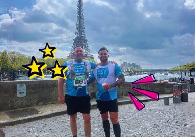 Two men standing in front of eiffel tower in Paris after a run in MHUK t-shirts