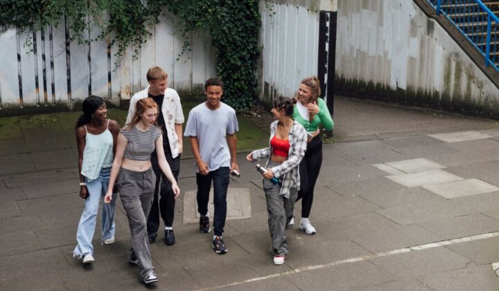 A group of young people talking outside